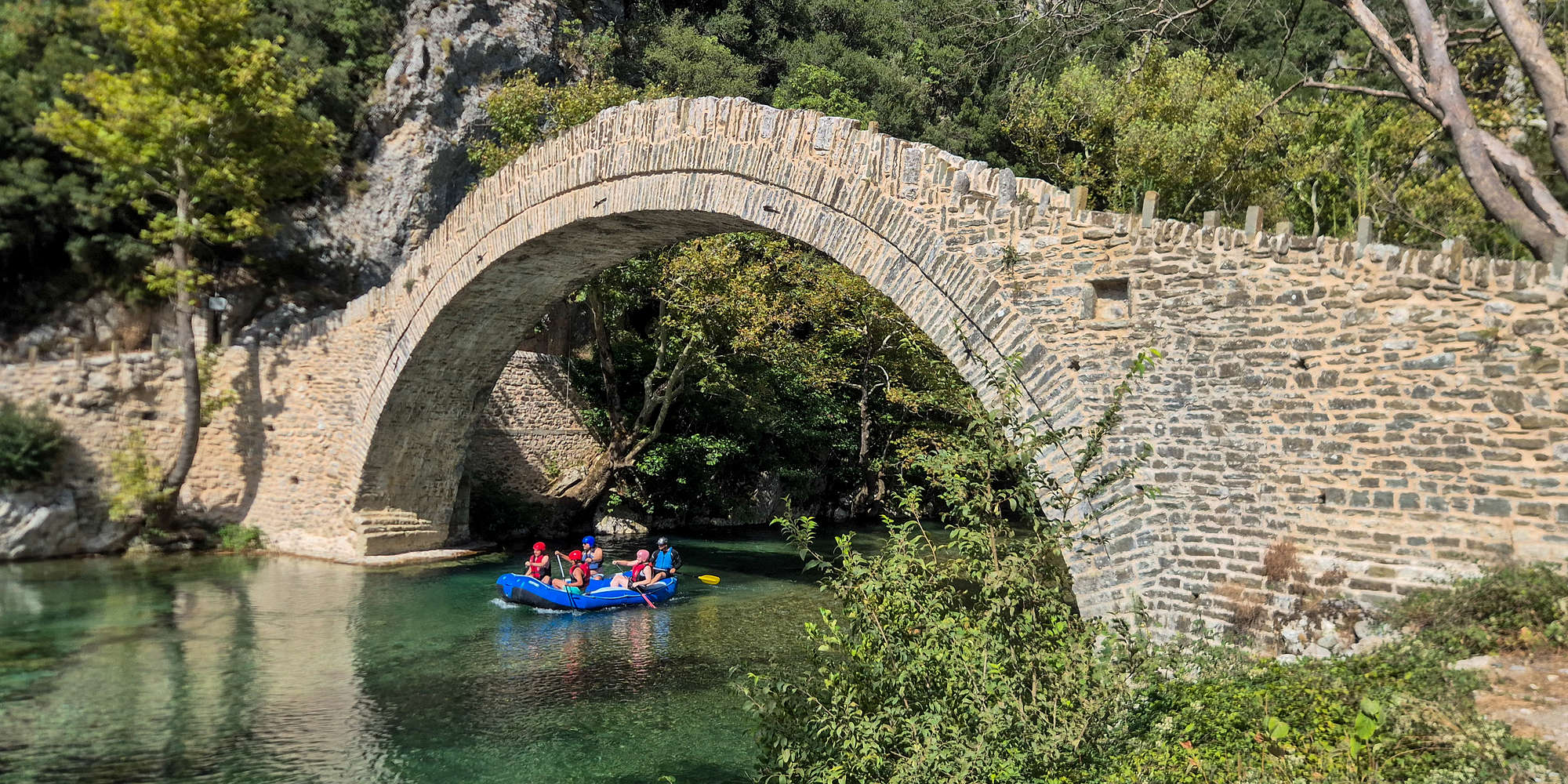 Rafters passing below the bridge.