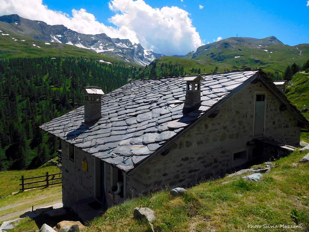 Aosta Valley typical house with stones roof, Alpe Champlong