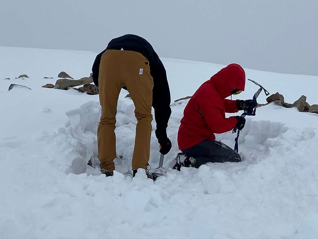 Digging out a spot for the tent at the base of Tempest