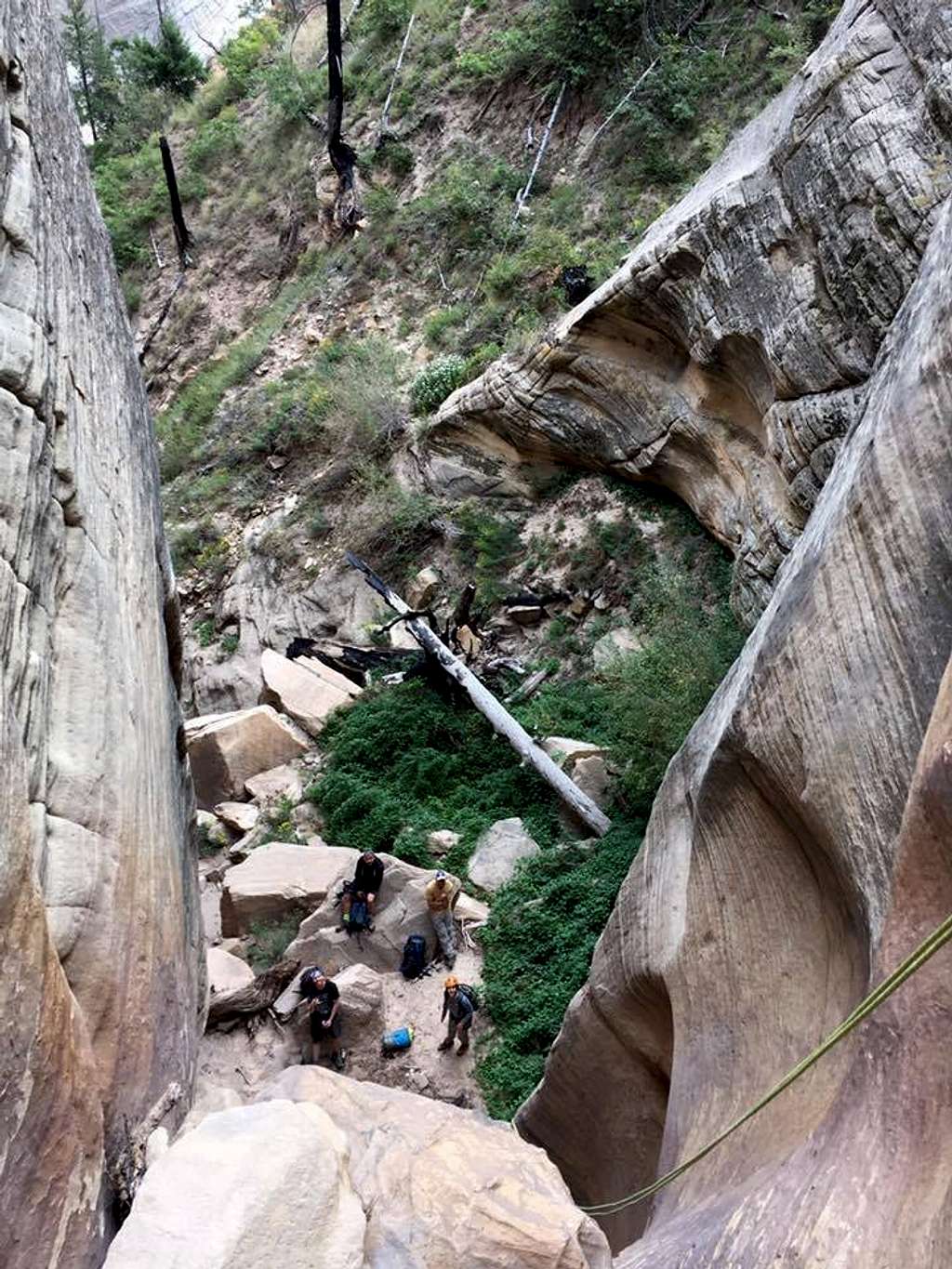 A group at the at the bottom of the last rappel of of Telephone Canyon