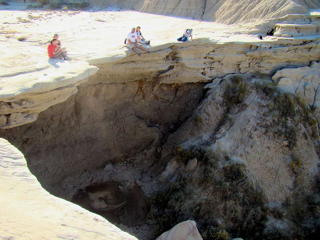 Hikers Relaxing on the Edge of a Dry Waterfall