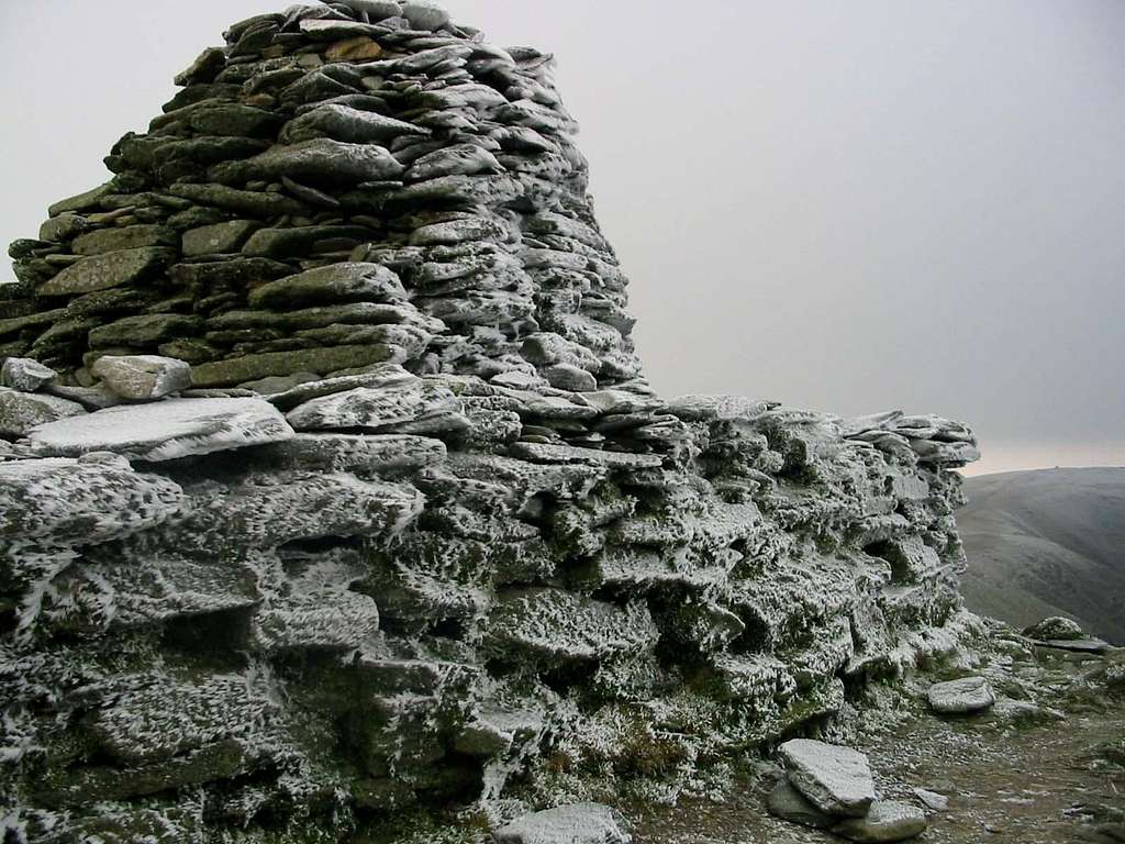 An ice encrusted summit cairn.