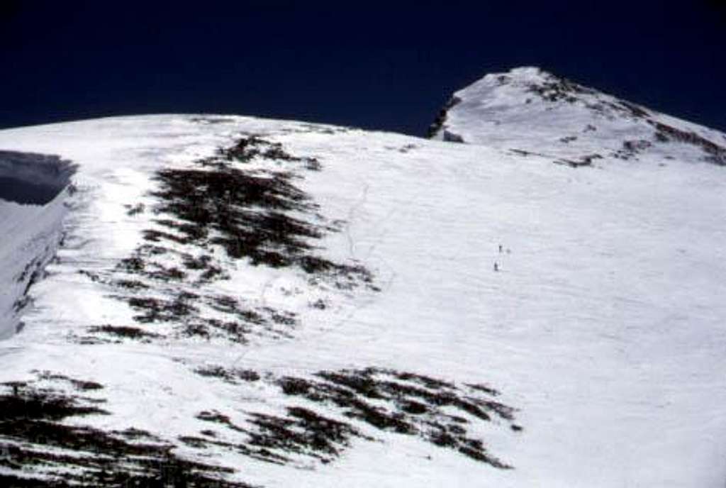Skiers ascend Mt. Dana's West...