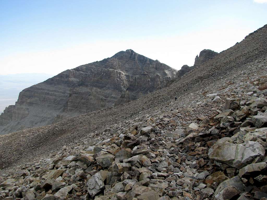 A hiker probes his way through the scree...