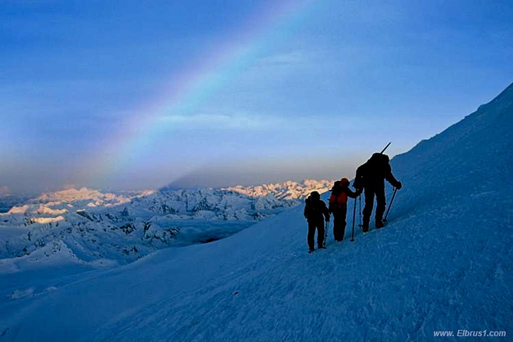 Climbing Elbrus vith Rainbow light background...
