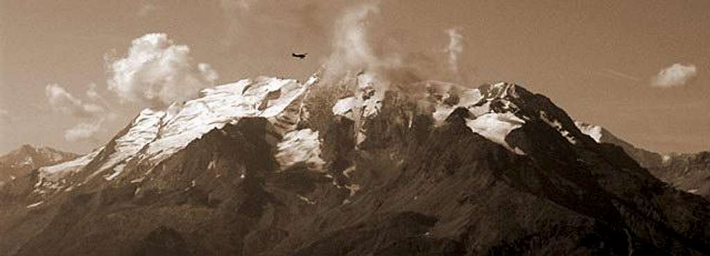 A small airplane flies over Mont Pourri group