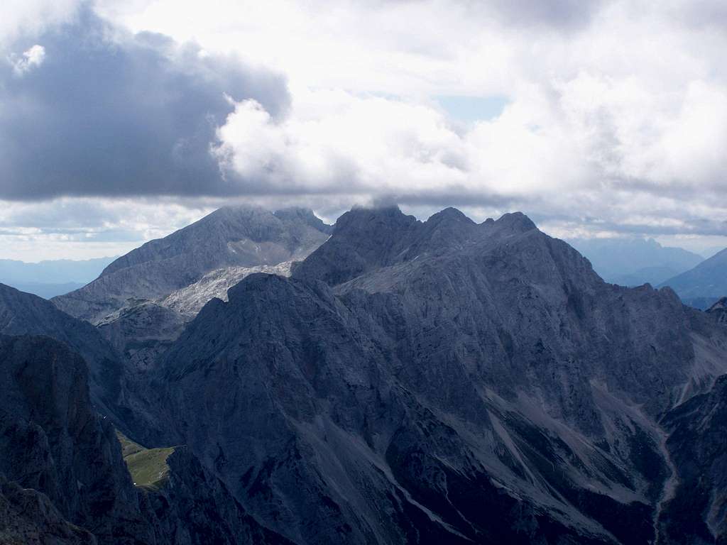 The peak of Skuta in clouds. Grintovec in the background