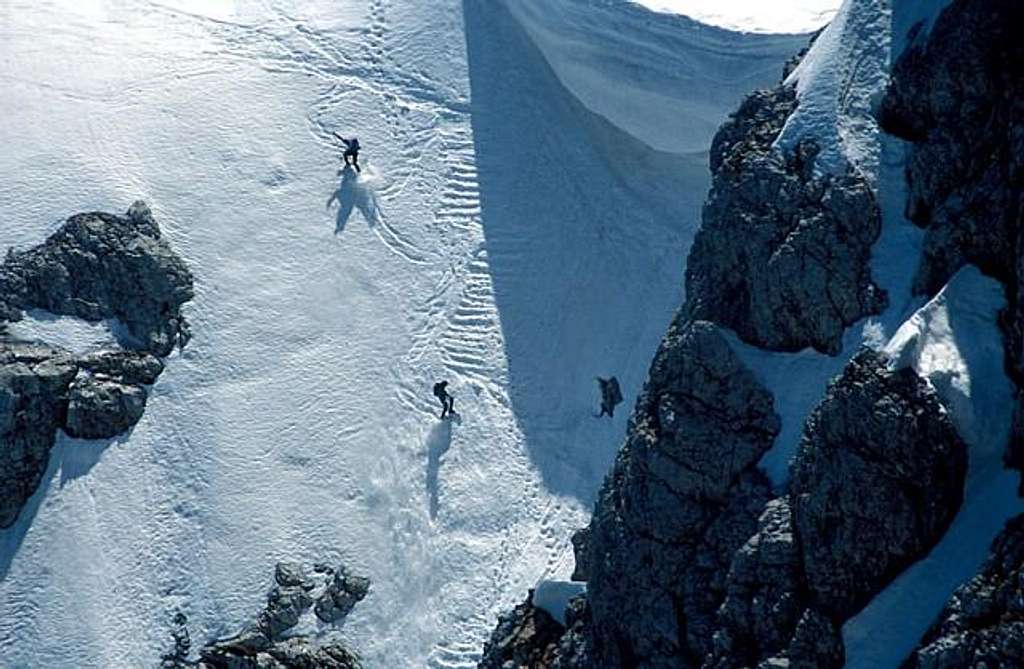 Two skiers descending the...
