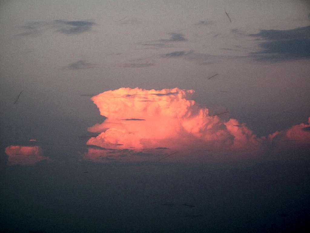 Close-up on the thundercloud illuminated by the setting sun