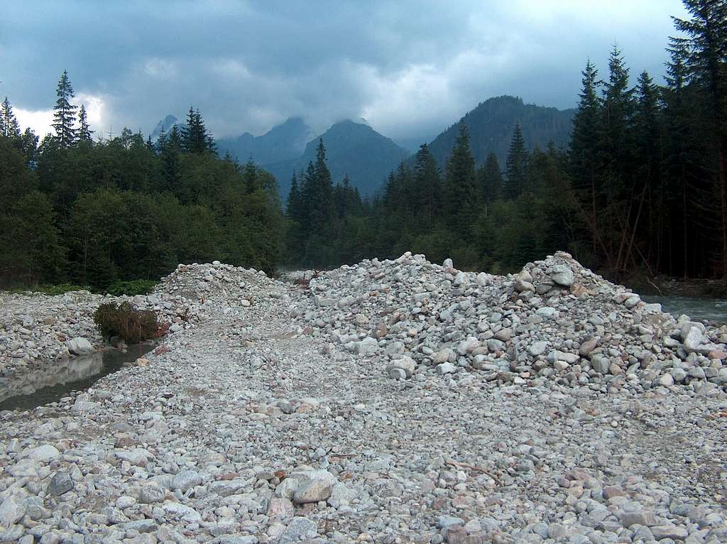 The capricous Bela Voda river carries masses of white granite peebles and boulders after every flooding