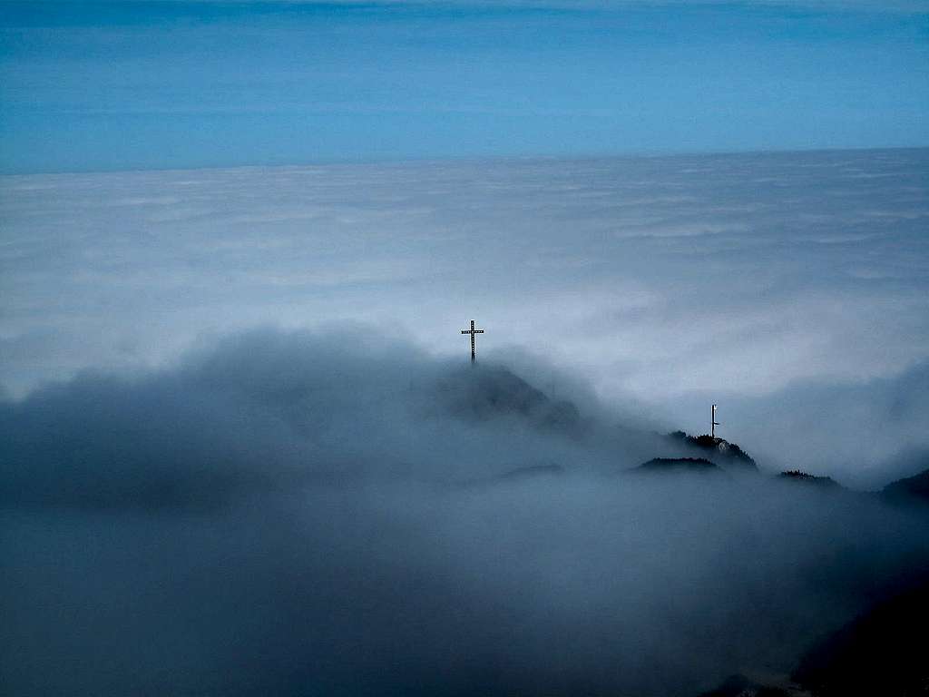 The summit cross of the Geiereck looking above the sea of clouds