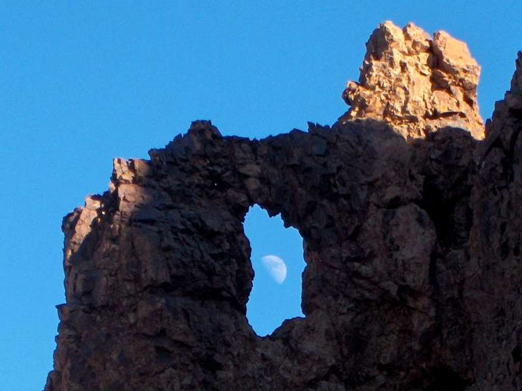 Moon shining through a hole in the crater rim