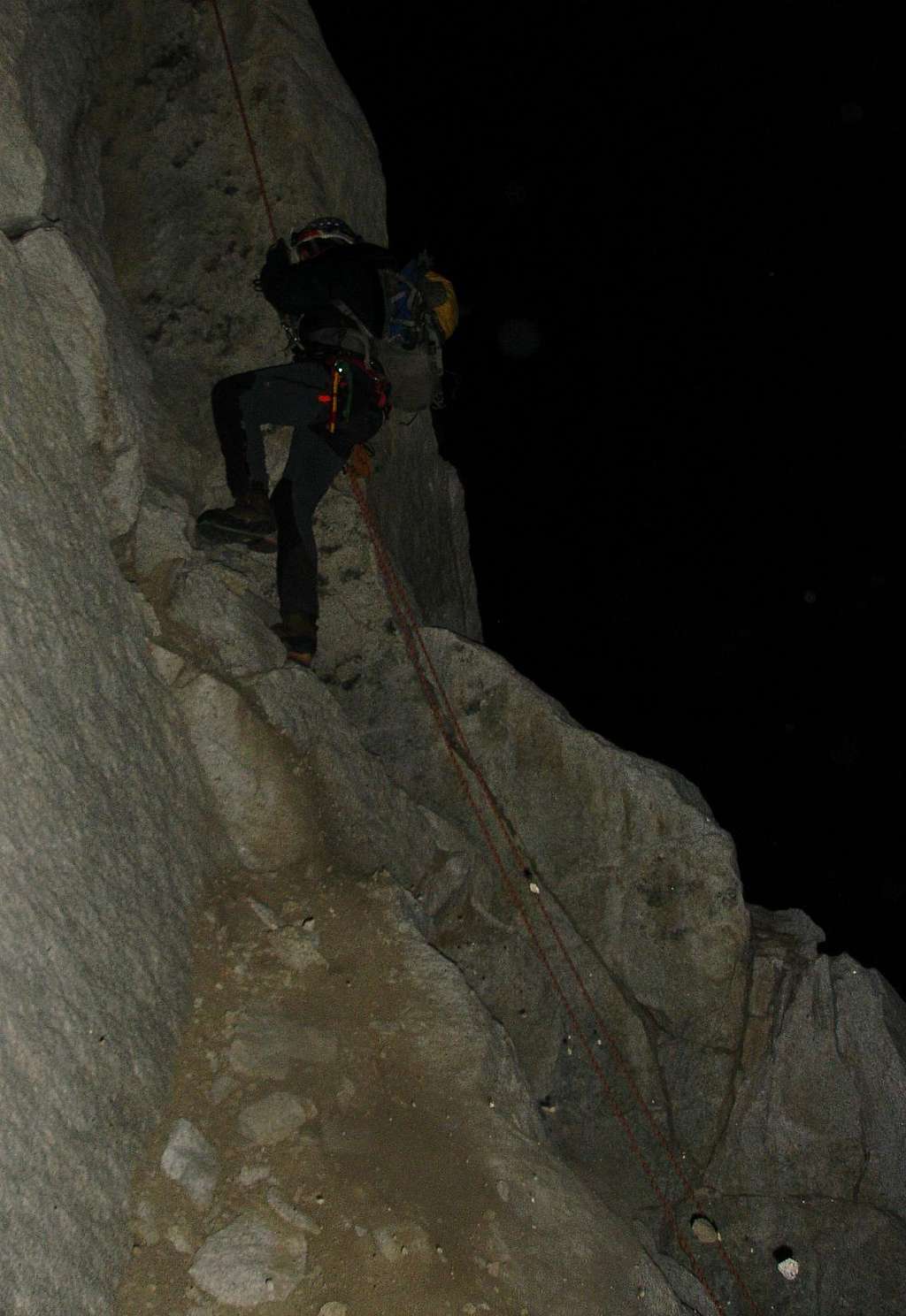Alex on one of the chossy lower cliff abseils, sometime around midnight. 