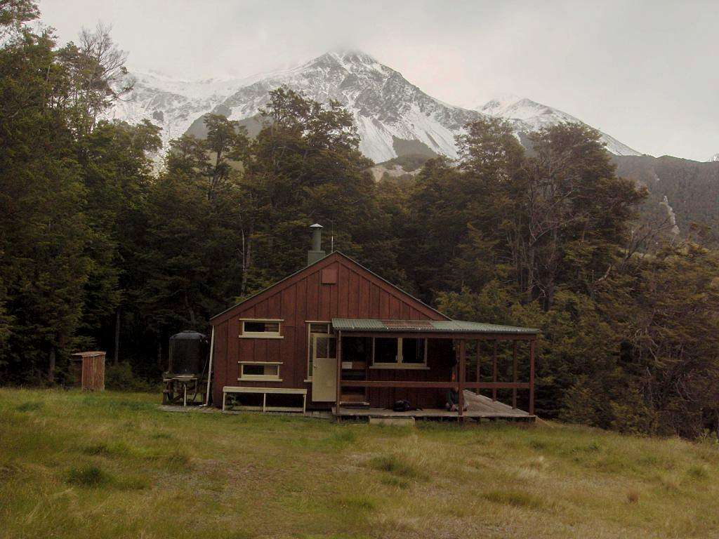 Hamilton Hut, with the mountains of the Craigieburn range in the background