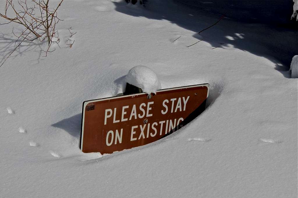 Snow buried sign