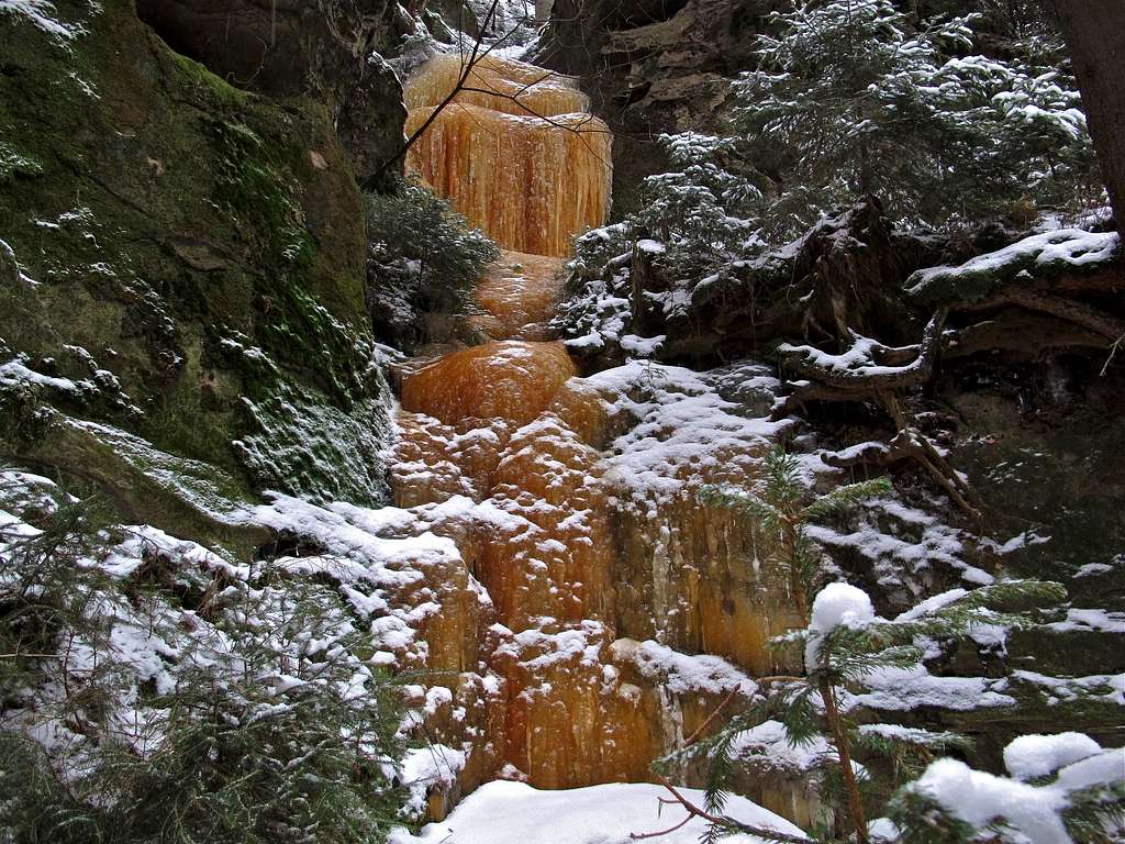 Orange colored frozen waterfall