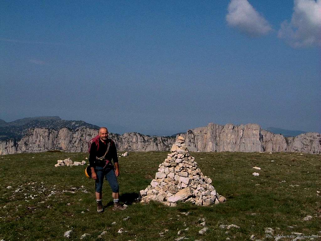 A lonely cairn over the wide summit of Mont Aiguille, Vercors 