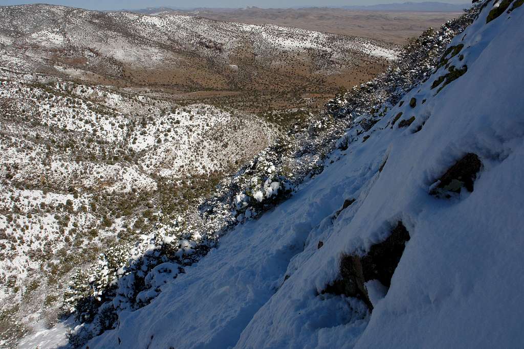 Traversing snow-covered slabs on the left side of the gully