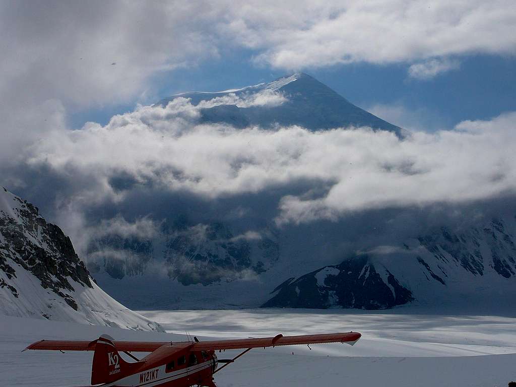 Mount Foraker from Kahiltna Base Camp with K2 plane ready for take off.