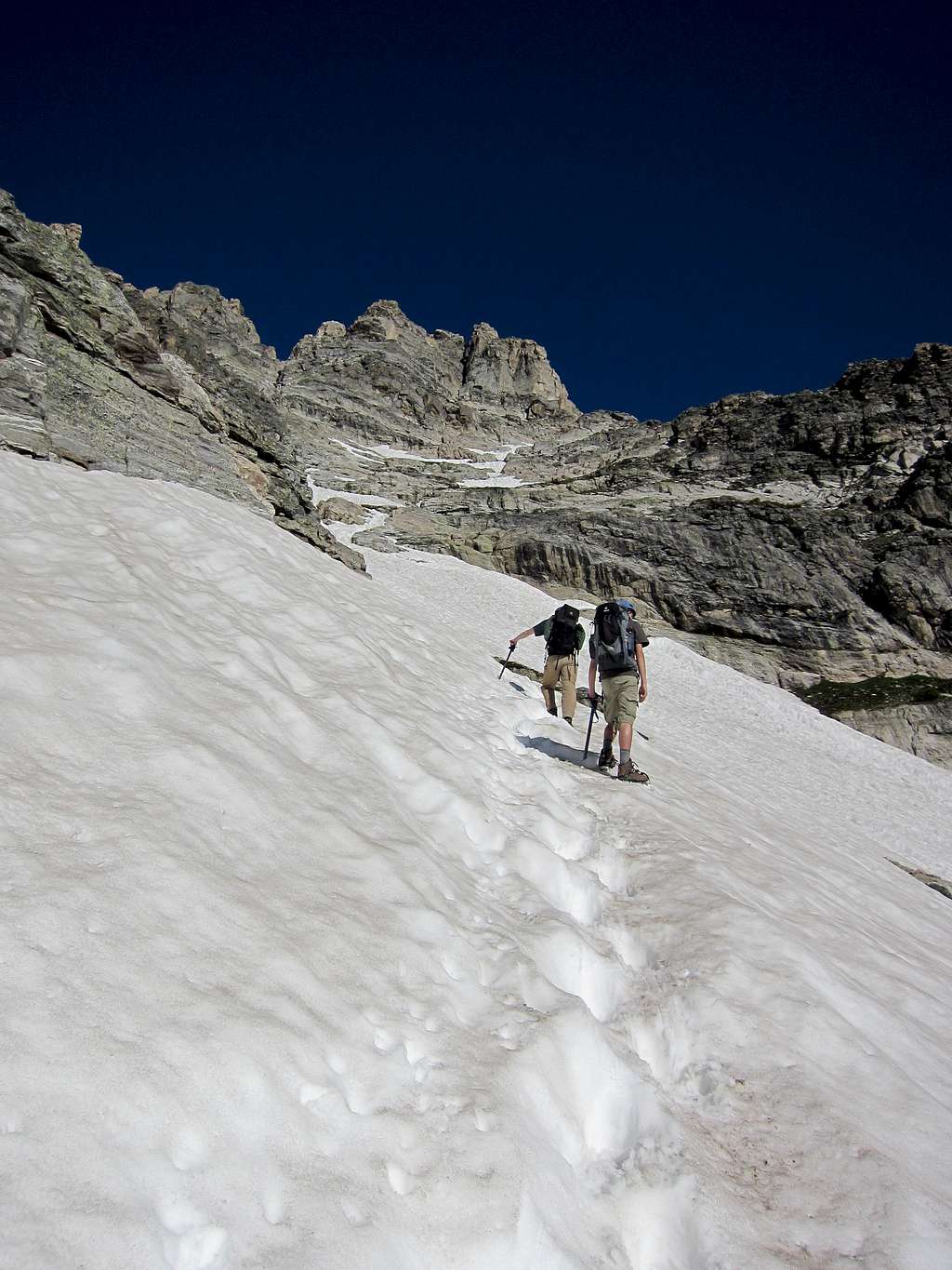 Myself and my little brother heading up a snowfield on the east face of Teewinot