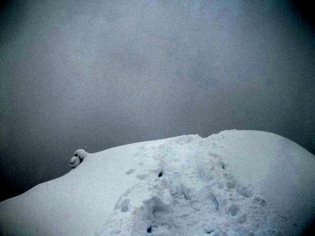 The snowy dark summit of Low Mountain