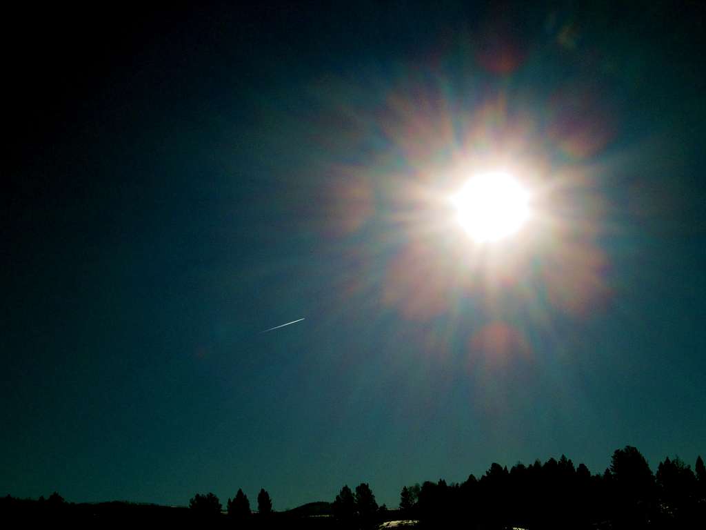 Plane flying into the sun, Blacktail Plateau, Yellowstone National Park