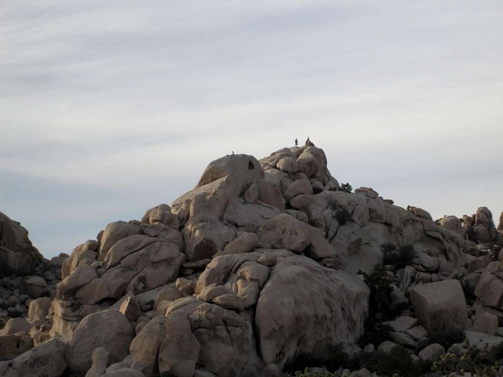 Climber on top of boulders inside the Hidden Valley Campground, Joshua Tree National ParK