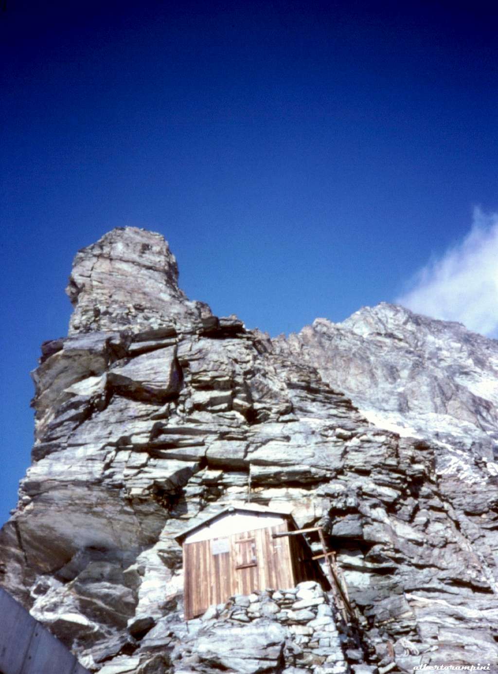 A historical image of the ancient hut, now destroyed, below the Grande Tower