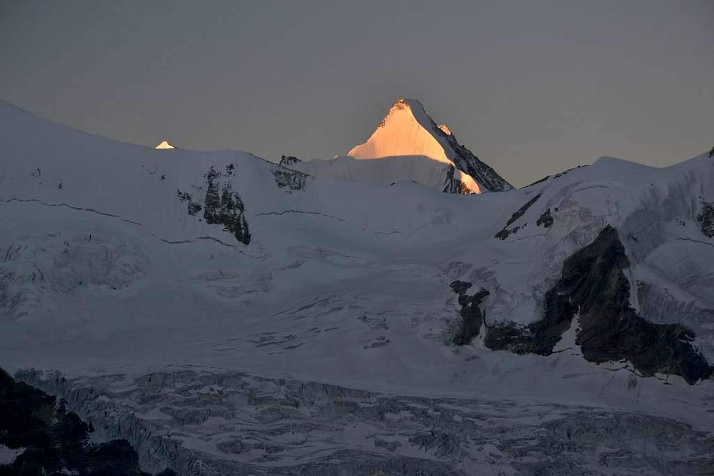 The first sunlight hits the ice north wall of Obergabelhorn