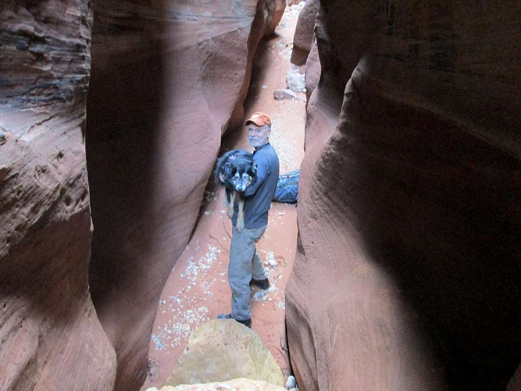 My dad helping my dog Cinco over a drop in a slot canyon, Grand Staircase-Escalante National Monument