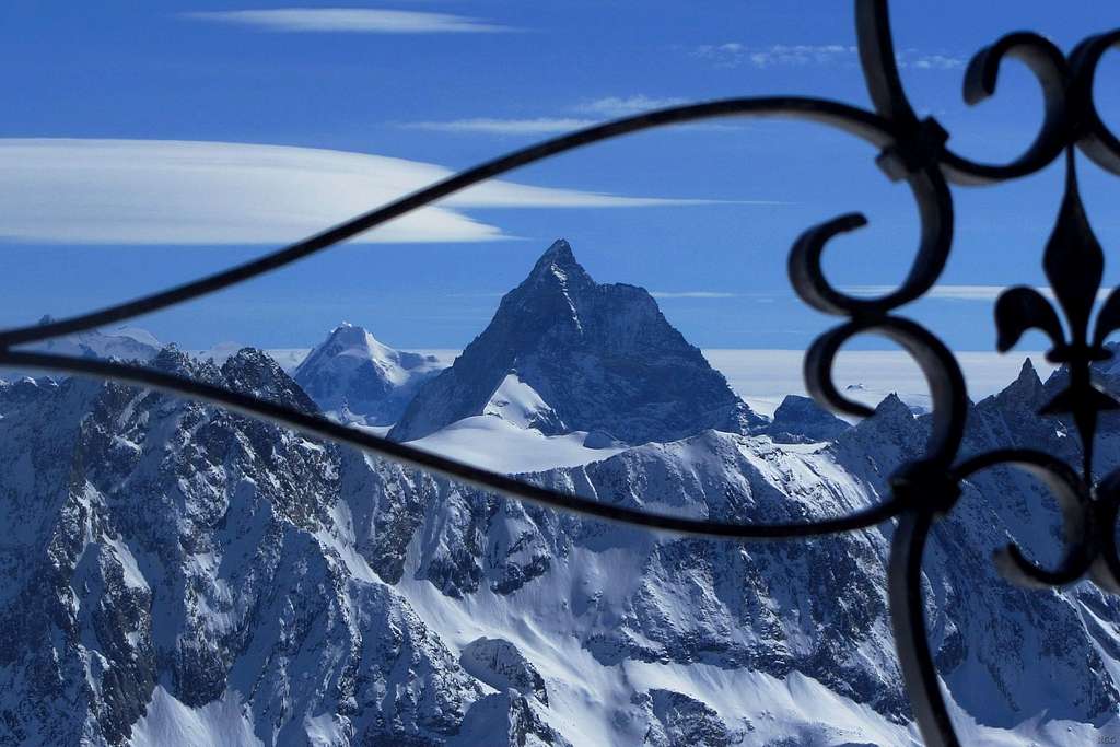 Zooming in on the Matterhorn through the wrought iron of the Pointe de Vouasson summit cross