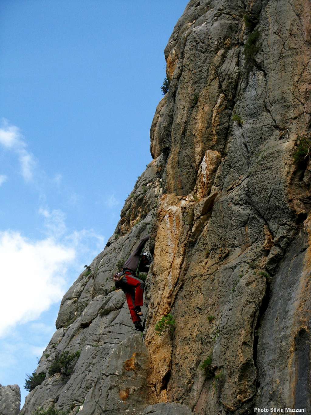 A climber negotiating a steep pillar, Monte Oddeu
