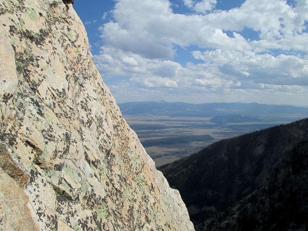 Looking out towards the valley floor from the top of pitch 2 of the Southwest Ridge of Symmetry Spire, Teton Range, WY