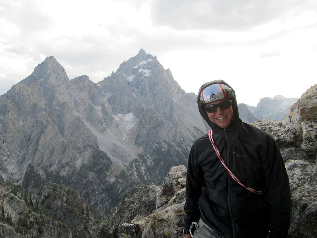 JD with Teewinot, Mt Owen, and The Grand Teton behind him at the base of the final pitch of the Southwest Ridge of Symmetry Spire, Teton Range, WY