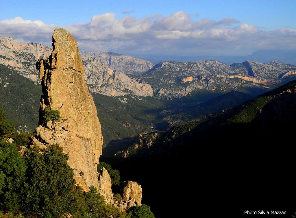 Granite needle along Orientale Sarda, back the wild Supramonte