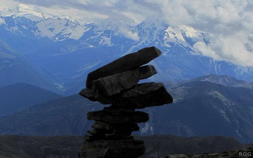 Cairn on the Elferspitz summit against the backdrop of the glaciated peaks of the Ortler group