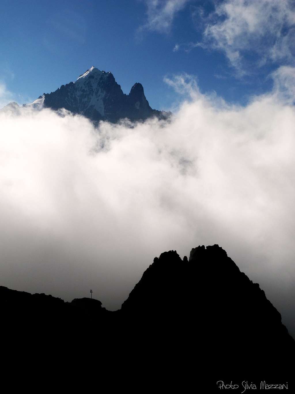Petit Dru and Aiguille Verte stand out the clouds