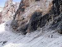 Hikers traversing the base of...