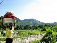 woman with heavy load in mountains on way to Pic La Selle