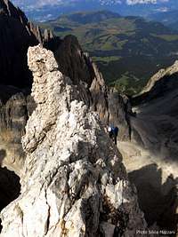 A climber while reaching Pollice summit, Sassolungo
