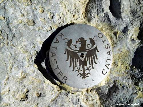 Monte Popèra summit benchmark depicting the tridentine eagle