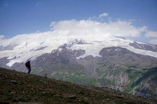 A hiker and Mount elbrus (5642m) as seen from Cheget Peak