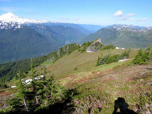 Looking down the steep grassy slope and Mt. Baker