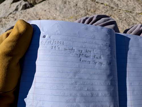 Summit register entry on a windy day