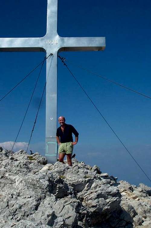A huge cross tops the peak. A...