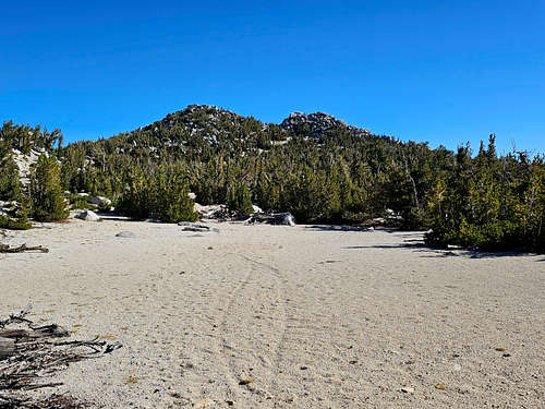 Sandy ground and the two summits of Monument Peak