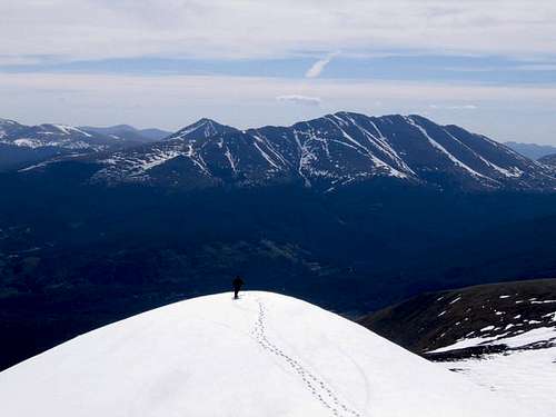 A skier on the lower summit...