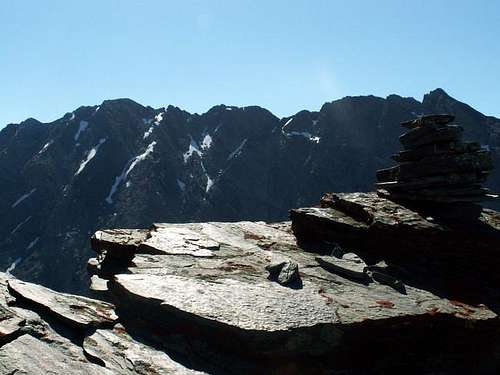 The summit cairn sits on a...