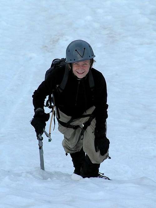 Monty ascending steep snow slope