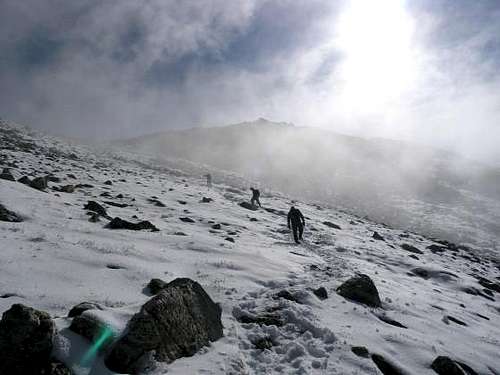The snowy, steep talus climb